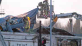 Firefighters at the Clutha bar in Stockwell Street, Glasgow, after police helicopter crashed into the roof of the building