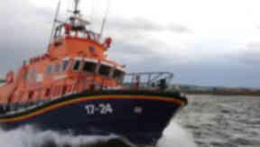 Rescue: Lifeboat crews assist cargo ship.
