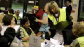 Count: Election workers sift through the ballots.