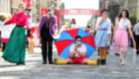 Festival: The Fringe brings colourful scenes to Edinburgh every August.