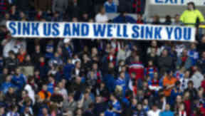 Rangers fans with "sink us and we'll sink you" banner.