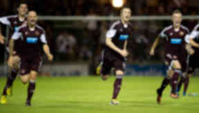 Hearts captain Danny Wilson (centre) and his team mates rush to celebrate with penalty shoot-out hero Brad McKay after sending Hearts through to the 3rd round of the Scottish League Cup