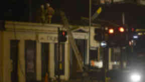 Firefighters at the scene of the police helicopter crash at the Clutha Vaults pub, November 29 2013.