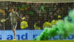 Fraser Forster stands next to a smoke bomb during Celtic's win at Motherwell.