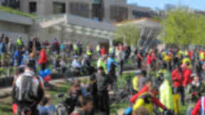 Cyclists gather outside the parliament after riding down the Royal Mile
