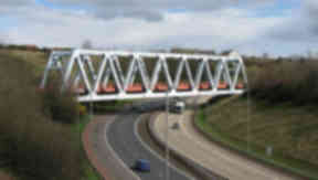 Railway bridge over M80 motorway near Junction one and two Blochairn and Robroyston carrying Stepps Cumbernauld railway line