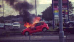 Car on fire on back of tow truck outside Forge Shopping Centre in Glasgow. Twitter image from Danielle Middleton. August 15 2014