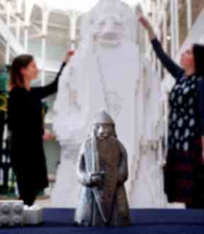 Finishing touches: Museum staff Lyndsay McGill and Alice Wyllie complete the sculpture.