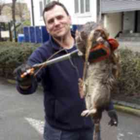 Electrician James Green with the giant rat which is said to have weighed 25lbs.