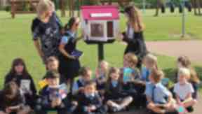 Swap shop: A group of pupils look after the school's outdoor library.