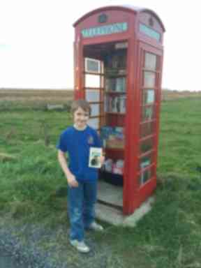 Community project: Mark used the donations from the phone box library to buy his school football team's new strip.