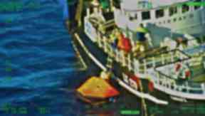 Rescue: Fishermen pulled from liferaft by crew of Fairway II.