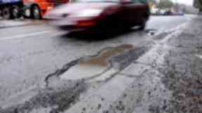 Pothole: Scotland has almost 38,000 miles of roads to maintain (file pic).