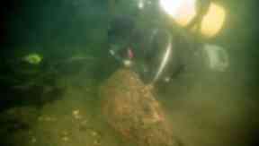 The mushroom-shaped anchor lies beneath the loch