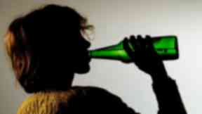 A woman drinking alcohol.