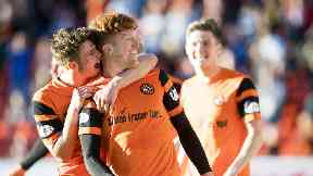 Simon Murray celebrates Dundee United's lead with his team mates.