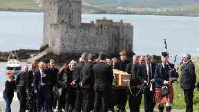 Funeral: A piper led a procession to the shore after Eilidh was flown home.