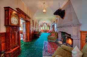 The grand hallway features an open fireplace.