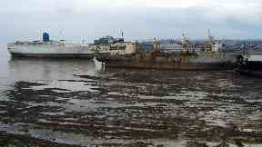 Beached: Empress of Britain, far left, scrapped in Alang, India.