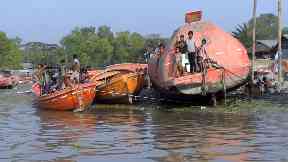 Children: Boys play on lifeboats taken from scrapped ships.