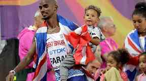 Farah leaves the track with his children after taking silver in the Men's 5000m .