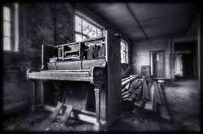A piano sits among the rubble.
