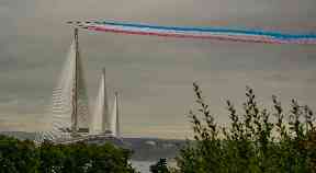 Plumes of red, white and blue smoke over the new Forth bridge.