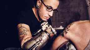 JC Sheitan Tenet uses the first prosthetic tattoo gun.