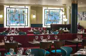The restaurant pays homage to the paper's past from the design to the artwork.