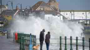 Dog walkers in Penzance watched as high waves crashed against the harbour.