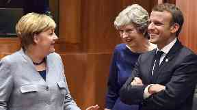 Mrs May spoke jovially with Angela Merkel and Emmanuel Macron.