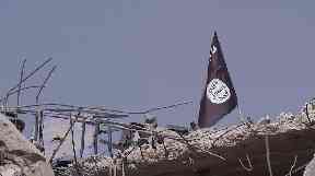 An IS flag a symbol of the brutal regime suffered by a battered city.