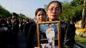 Black-clad mourners thronged the streets to pay their respects