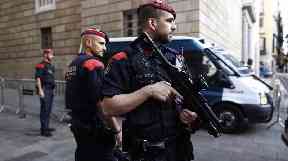 Catalan police officers stand guard the entrance of the Palau Generalitat in Barcelona