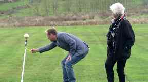 John Noakes's wife watches as their son lights the firework.