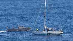 A US Navy boat circles the women's yacht.