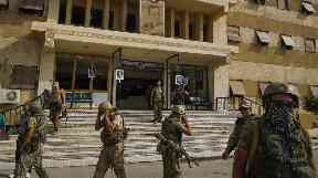 Russian military police soldiers walk outside a hospital in Deir ez-Zor.