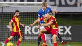 Rangers' Ross McCrorie vies with Partick Thistle forward Connor Sammon for possession.
