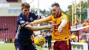 Ross County defender Marcus Fraser challenges Motherwell forward Louis Moult.