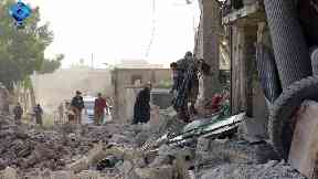 Residents inspect the rubble in the aftermath of the attack.