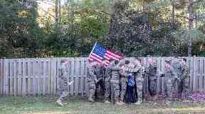 The servicemen embrace Cassie after the reveal.