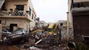 The flooding swept vehicles away and damaged buildings.