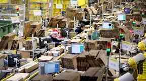 Staff label and package items in the on-site dispatch hall inside one of Britain's largest Amazon warehouses in Dunfermline.