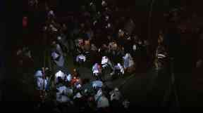 Emergency workers wrap evacuated residents in blankets.