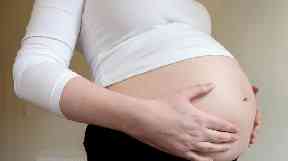A woman in the third trimester of pregnancy.
