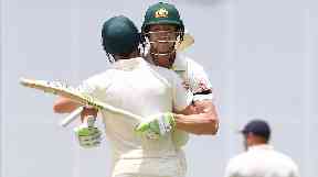 Australian batsmen David Warner (right) and Cameron Bancroft celebrate after Australia won on Day 5 of the First Test match between Australia and England at the Gabba in Brisbane.