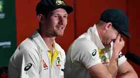 Smith stifles his laughs during press conference.