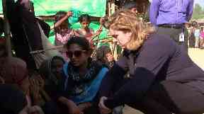 Penny meets refugees at the camp.