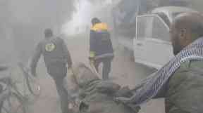 An elderly man is carried away from the scene of the bombing.
