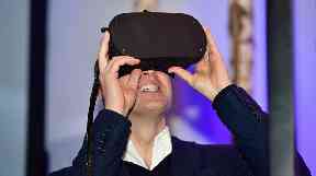 Prince William tries out a virtual reality headset at a tech festival in Helsinki.